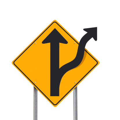 An off-road traffic sign post over a white background showing an alternative direction - a clipping path is included to separate sign