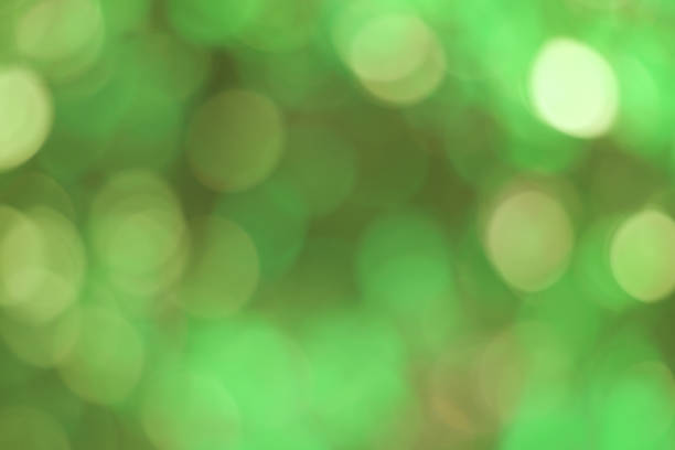 istock Green bokeh abstract, pattern of blurred bright light in natural background. 1658592041