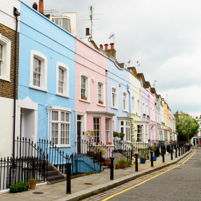 A colourful row of pastel painted Victorian townhouses in Chelsea, London.