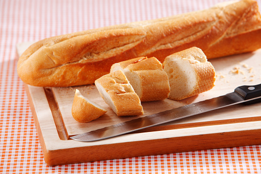 sliced baguette on cutting board