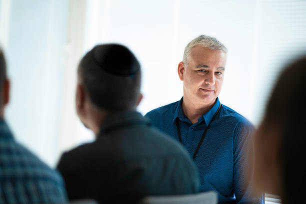 istock Mature Jewish market agent leading group training session. 1658636115