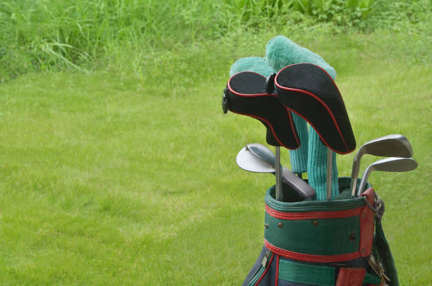 Closeup rear view of a young man hitting a driver shot.