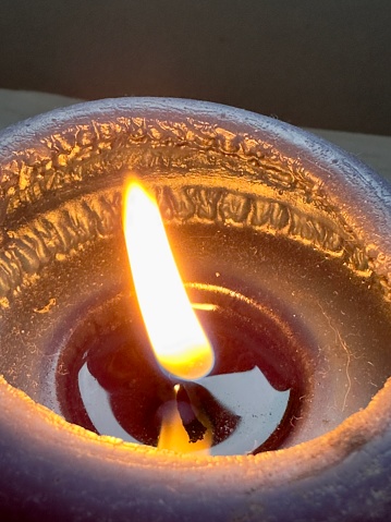 Typical swedish advent candle stick with decorations and one candle burning