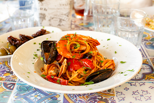 Italian Pasta with seafood Spaghetti allo scoglio, with shrimps, mussels, clams, vongole, tomatoes, parsley. Sicilian restaurant.