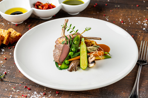 lamb chops with various vegetables at a fine dining restaurant