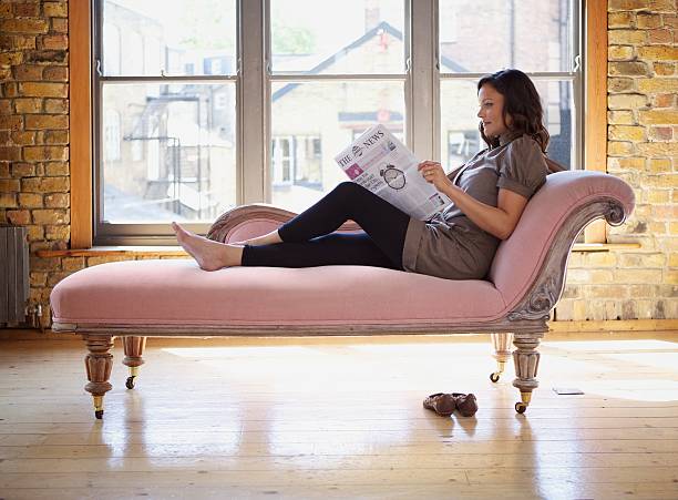 Che's Lounge... A young woman lying on a Che's Lounge... chaise longue woman stock pictures, royalty-free photos & images