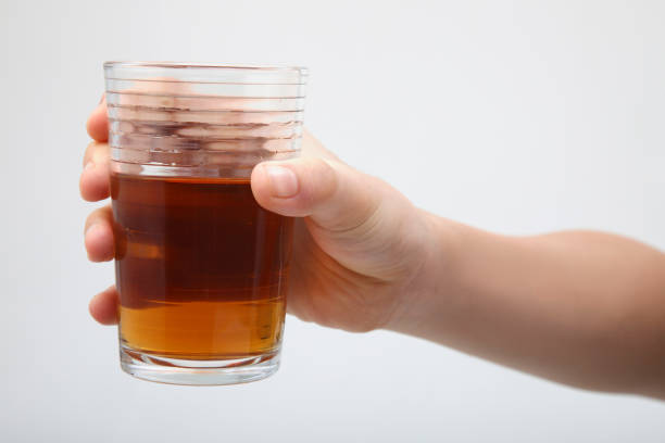hand holding  a glass of tea