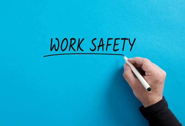 istock Male hand underlines the word Work Safety on blue background. 1658697576