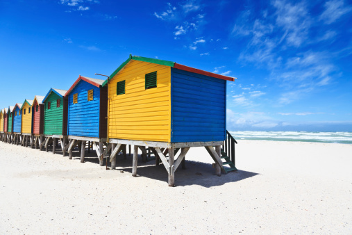 Several of the 82 colorful Victorian bathing boxes along Dendy Street Beach, timber structures facing W.to Port Phillip Bay seen in the late afternoon, Brighton Beach Suburb. Melbourne-VIC-Australia.