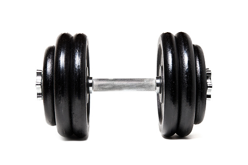 Gym dumbbell isolated over white background, side view.