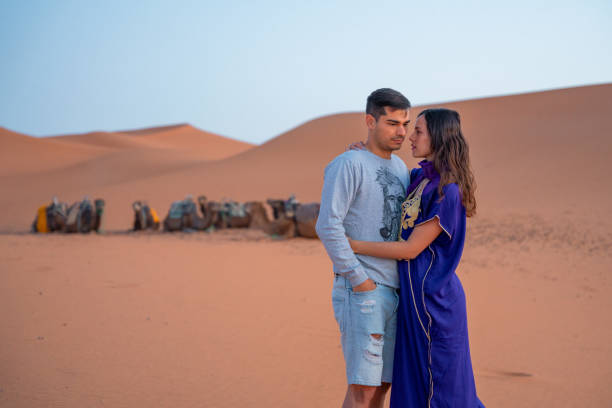 istock Couple hugging each other in the desert 1658739584