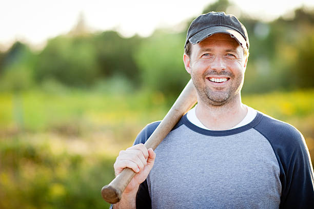 istock Happy, Vintage Baseball Player with Bat Outside During Summer 165874327