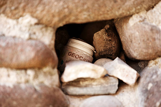 Geocaching location hidden in wall stock photo