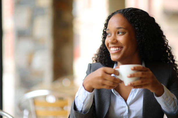 istock Happy black executive looking at side in a coffee shop 1658749130