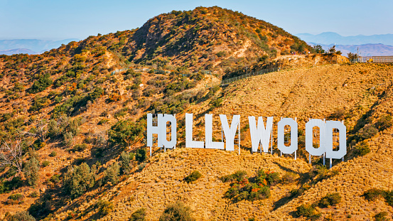 City Of Los Angeles, CA / USA - July 27, 2022: Aerial view of Hollywood sign on Mount Lee, Hollywood, City Of Los Angeles, California, USA.\n\nThe Hollywood Sign is an American landmark and cultural icon overlooking Hollywood, Los Angeles, California.
