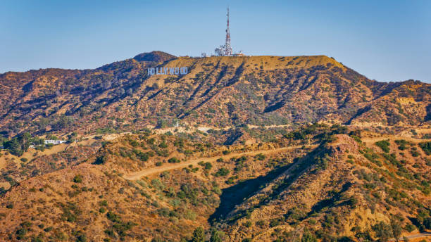 City Of Los Angeles, CA / USA - July 27, 2022: Aerial view of Hollywood sign on Mount Lee, Hollywood, City Of Los Angeles, California, USA.The Hollywood Sign is an American landmark and cultural icon overlooking Hollywood, Los Angeles, California.