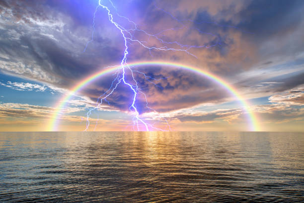 istock Calm sea before storm with amazing rainbow and lightning at sunset 1658754517