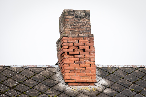 Old brick chimney, heating season. Repair and renovation.