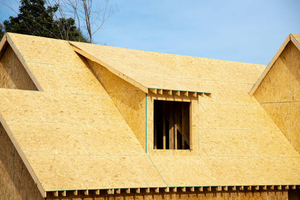 Gabled dormer roof with oriented strand board (OSB) plywood sheeting ridge edge envelope in residential house construction project in suburbs Atlanta, Georgia, USA stock photo
