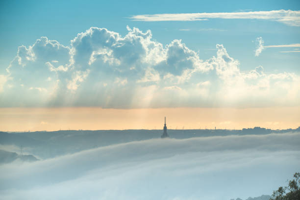 Twilight Transformation: Urban Landscape Surrounded by Post-Rain Clouds. View of the urban landscape from Dajianshan Mountain, New Taipei City, Taiwan.