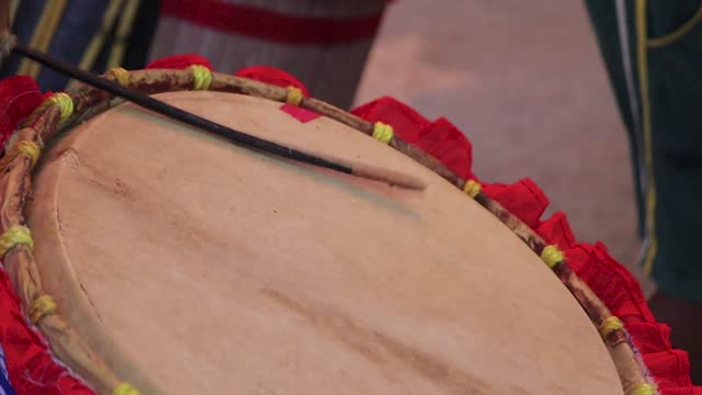 Dhak being played during durga puja with cane sticks. This membranophone musical instrument is part of bengali culture and mostly seen during hindu festival of worshipping goddess durga.
