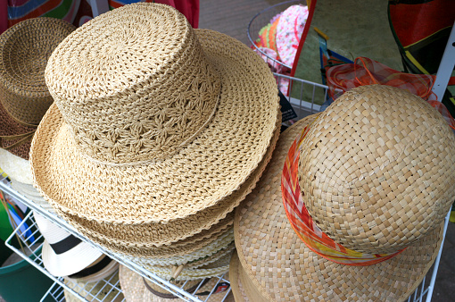 Pile of many straw hats for women