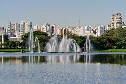 Sao Paulo, Brazil, skyline viewed from the lagoon and fountains of Ibirapuera Park