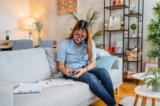 istock Young Woman Checking Her Finances Using Smart Phone 1658793768