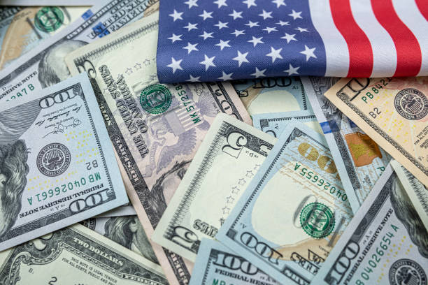 istock American flag with different american banknotes 1658795991
