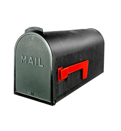 A black country and rural mailbox with the flag down and copy space on the mailbox. The photograph is taken from a studio location with a bright white background. The photograph is well lit from all angles with studio quality lighting.