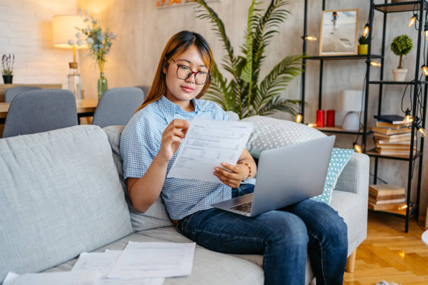 istock Young Woman Checking Her Finances Using Laptop At Home 1658806610