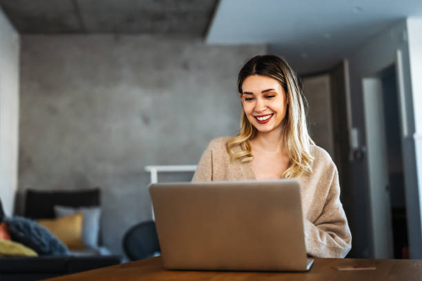 istock Home office. One smiling woman using laptop. Work, freelance, social media, technology concept. 1658813175