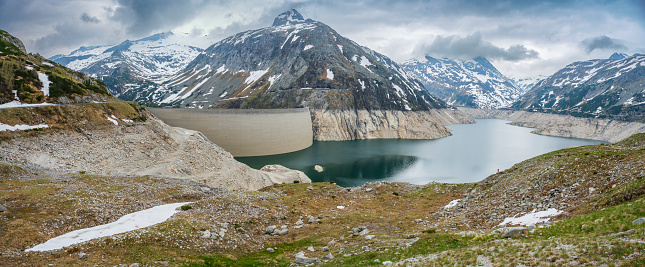 Kölnbrein Dam and the Koelnbreinspeicher reservoir in the Maltatal Carinthia Austria during an overcast springtime day in the Hohe Tauern range in the Alps.