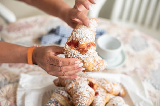istock Tasty brioche filled with jam, split by feminine hands 1658818004