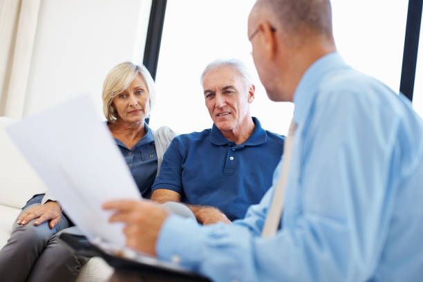 istock Financial planner explaining to elderly couple 165883927