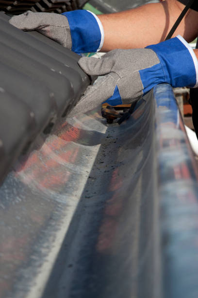 istock Laying tiles on a roof. 165884241
