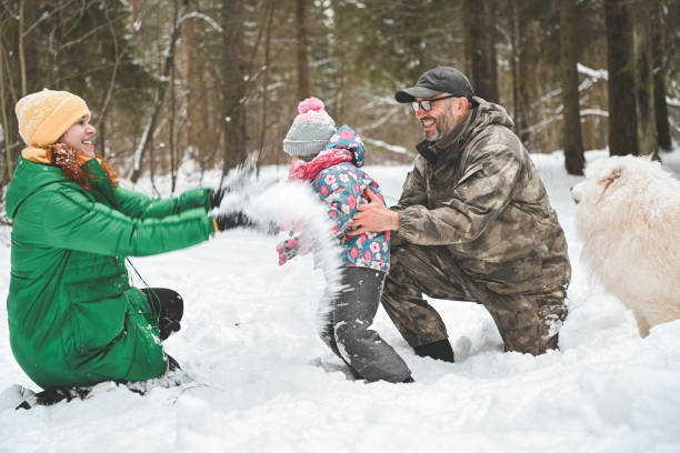 istock family walking in the winter forest 1658846140