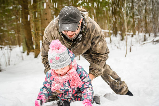 istock dad and daughter walk in the winter forest 1658849969