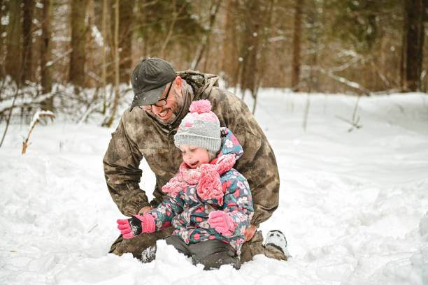 istock dad and daughter walk in the winter forest 1658854895