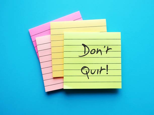 istock Notepad on blue backgroud with handwritten words DON'T QUIT, to encourage to try one more time, never give up and overcome obstacles to be success 1658858127