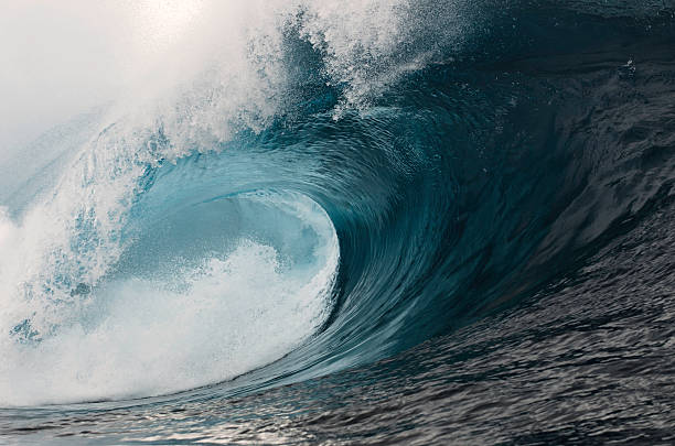 Cold Power A large powerful wave breaking. tsunami wave stock pictures, royalty-free photos & images