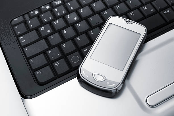 istock Smartphone on top of a laptop Keyboard 165886179