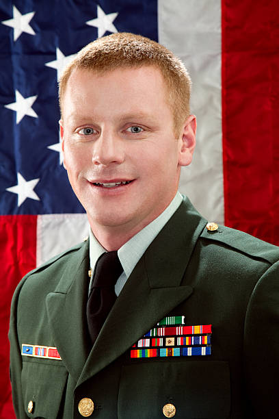 istock Decorated American Soldier with Class A Uniform Against USA Flag 165886258