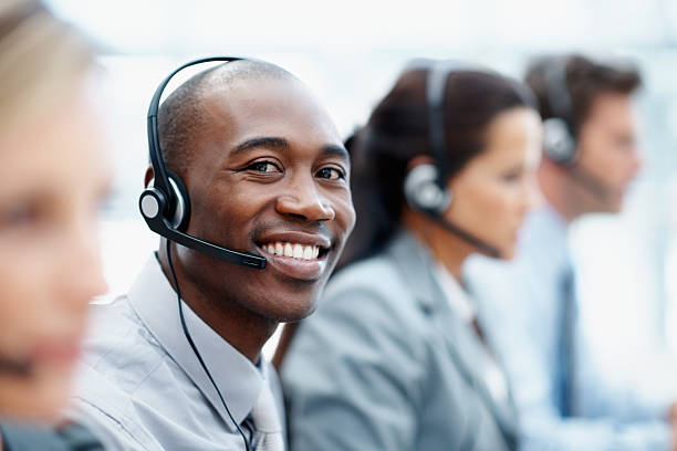 istock Call center employees wearing headsets in a row 165886517