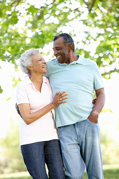 istock Senior couple walking through park on a sunny day 165886536