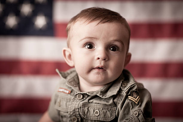istock Proud, Confident Baby Boy Thinking by American Flag 165886569