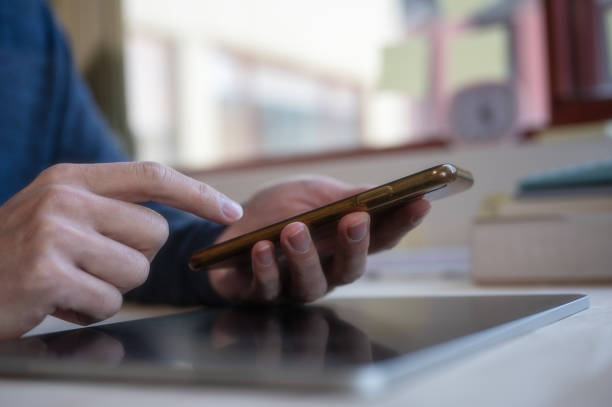 istock Social media marketing concept. Man hand using smartphone typing, chatting conversation in chat box icons pop up blurred office background 1658866386