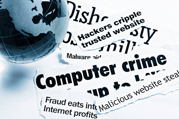 Glass globe paperweight on computer crime-related headlines