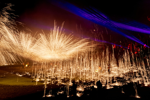 One of the traditional folk performances in Henan Province, China during the celebration of Chinese New Year，The iron flower is a large-scale traditional folk firework. It is a folk cultural performance technique discovered by ancient Chinese craftsmen in the process of casting utensils. The iron flower in Kaifeng, Henan, China is also known as the top ten folk arts in the Yellow River Basin, with more than ten Performers take turns using flower sticks to hit molten iron with a temperature of more than a thousand degrees into the sky, forming steel fireworks more than ten meters high. The scene is spectacular, showing thrilling, festive and lively characteristics.