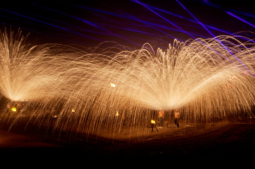 One of the traditional folk performances in Henan Province, China during the celebration of Chinese New Year，The iron flower is a large-scale traditional folk firework. It is a folk cultural performance technique discovered by ancient Chinese craftsmen in the process of casting utensils. The iron flower in Kaifeng, Henan, China is also known as the top ten folk arts in the Yellow River Basin, with more than ten Performers take turns using flower sticks to hit molten iron with a temperature of more than a thousand degrees into the sky, forming steel fireworks more than ten meters high. The scene is spectacular, showing thrilling, festive and lively characteristics.